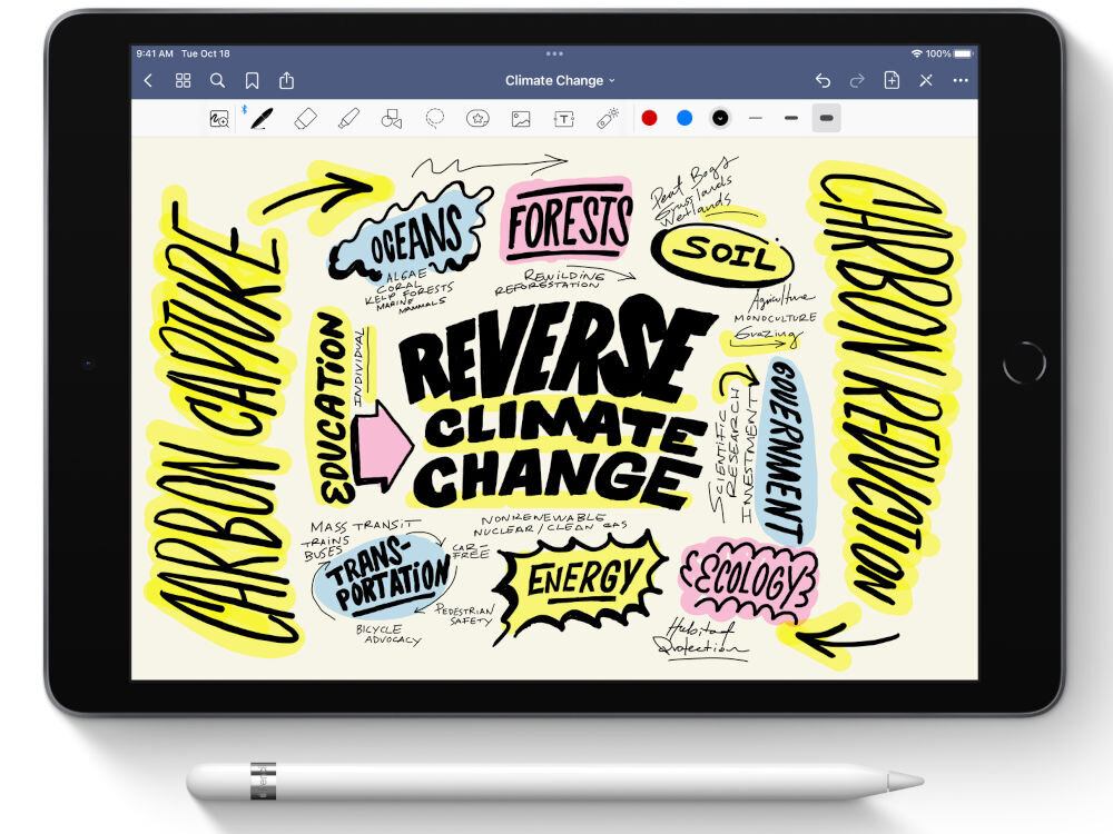 Tablet z wyświetlonym kolorowym diagramem na temat zmian klimatycznych, z centralnym napisem \'REVERSE CLIMATE CHANGE\'. Przed tabletem leży biały rysik.