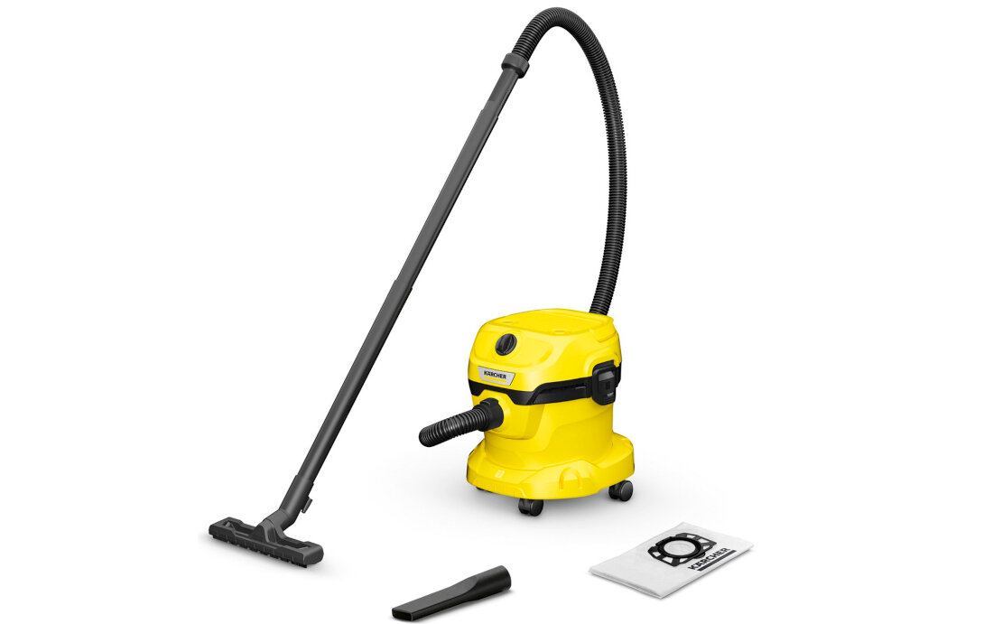 Żółty odkurzacz warsztatowy z czarną rurą i szczotką, obok leży dodatkowa końcówka oraz worek na kurz. Na odkurzaczu widoczne jest logo \'KARCHER\'.