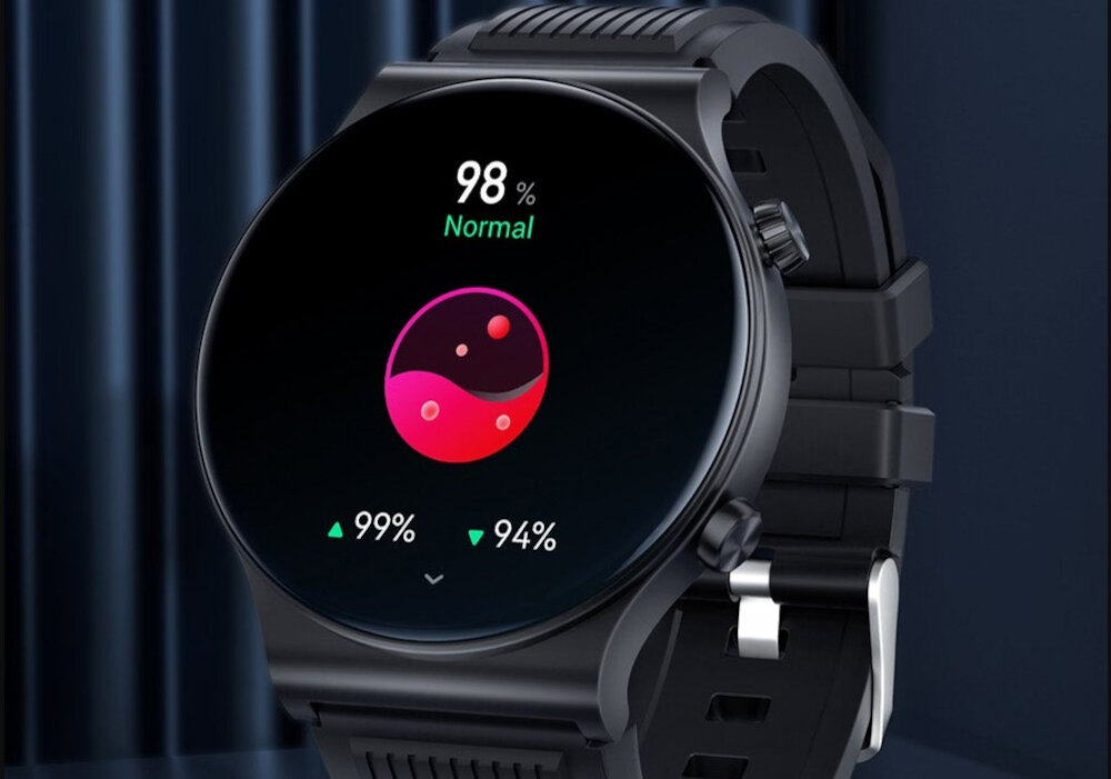 Czarny smartwatch z okrągłym wyświetlaczem pokazuje wskaźnik 98% z napisem \'Normal\'. Na ekranie widoczne są także wartości 99% i 94% oraz kolorowy wykres w kształcie yin-yang.