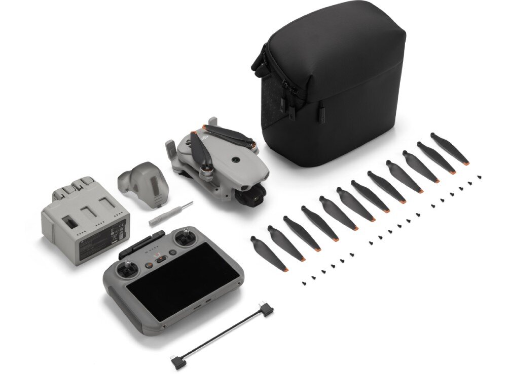 Dron DJI Lito X1 zestaw elementów na białym tle zawierający kontroler, złożonego drona, zapasowe śmigła, śrubokręt, kabel oraz osłonę gimbala