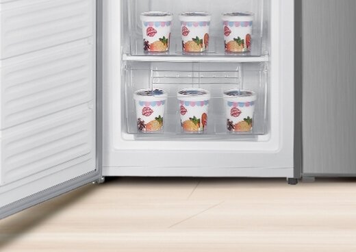 Wnętrze zamrażarki, zbliżenie na szufladę z lodami.