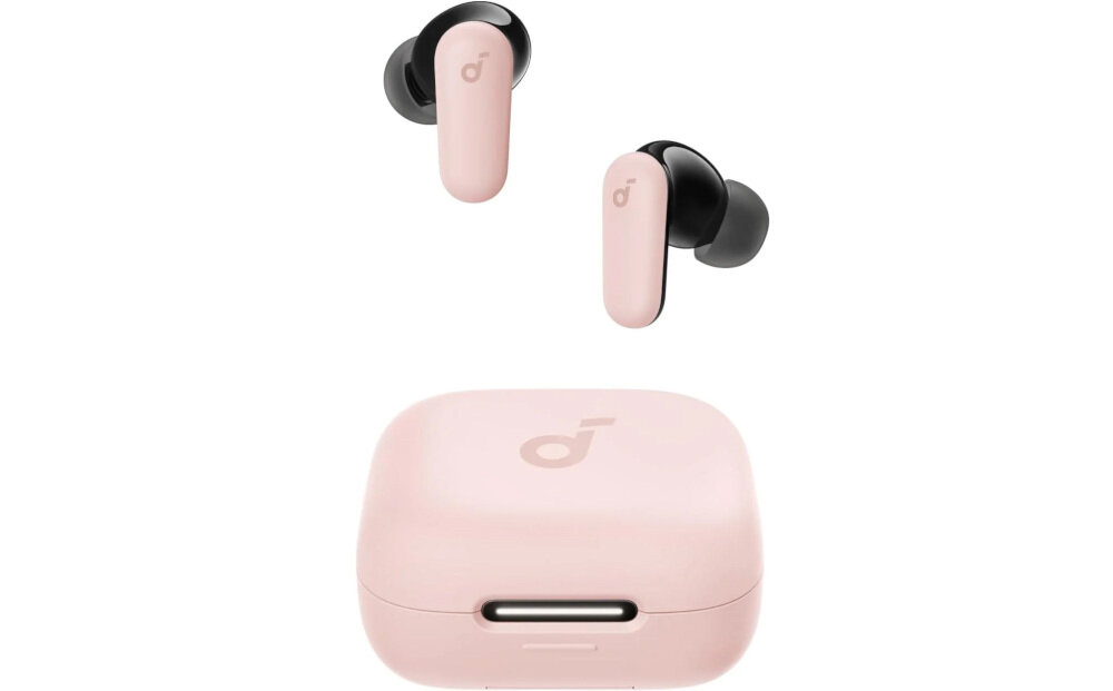 Na obrazie widoczne są różowe słuchawki dokanałowe z czarnymi elementami oraz etui ładujące w tym samym kolorze. Na słuchawkach i etui znajduje się logo producenta w formie stylizowanej litery \'d\'.