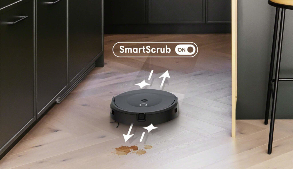 Robot sprzątający na drewnianej podłodze z plamami. Widoczny tekst: SmartScrub ON.