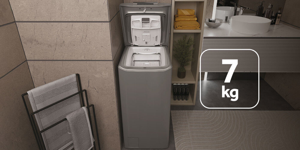 Pralka ładowana od góry znajduje się w nowoczesnej łazience. Na obrazie widoczny jest napis \'7 kg\'.