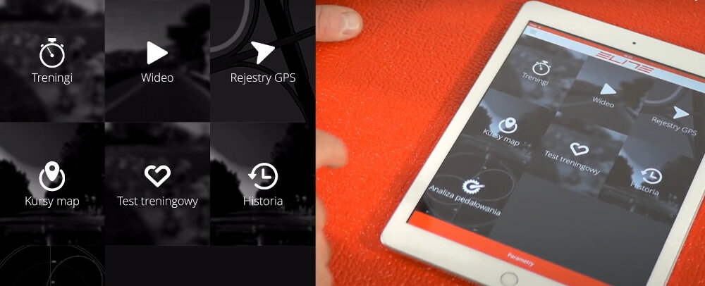 Tablet z aplikacją wyświetlającą opcje: Treningi, Wideo, Rejestry GPS, Kursy map, Test treningowy, Historia, Analiza pedałowania. Logo \'ELITE\' widoczne na górze ekranu.