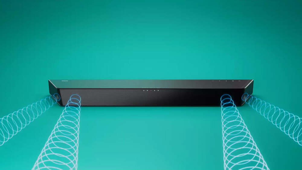 Czarny soundbar z widocznymi przyciskami na górnej powierzchni, umieszczony na tle w kolorze turkusowym. Z obu stron soundbara wychodzą niebieskie, spiralne linie symbolizujące dźwięk.