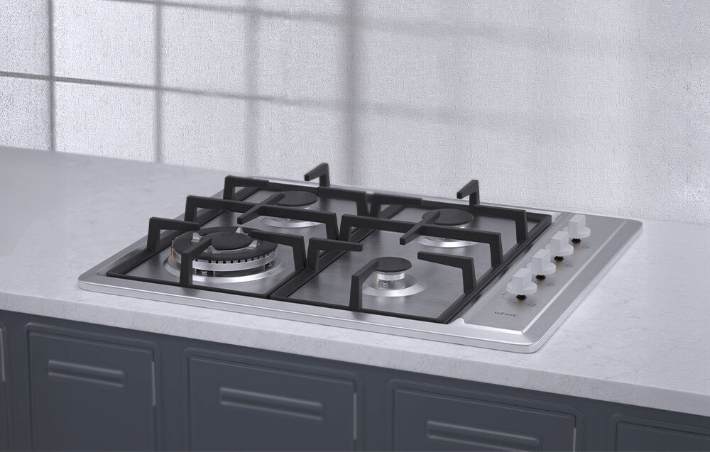 Na obrazie widoczna jest płyta gazowa z czterema palnikami i metalowymi pokrętłami umieszczonymi z boku. Płyta jest zamontowana na blacie kuchennym, a w tle widać szafki kuchenne.