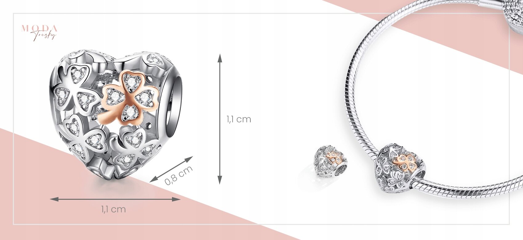 Obraz przedstawia charms w kształcie serca z motywem koniczynki, ozdobiony małymi kryształkami. Wymiary charmsa to 1,1 cm na 0,8 cm, a na zdjęciu widoczna jest również bransoletka z zawieszką.