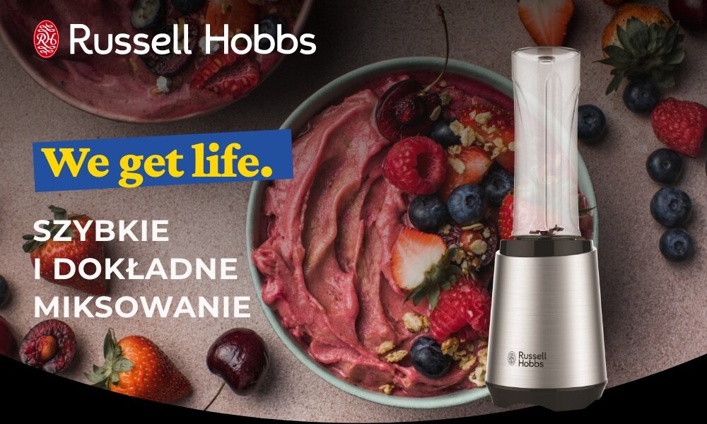 Obraz przedstawia blender personalny z logo Russell Hobbs obok miski z owocowym smoothie. Na obrazie widnieje tekst: \'We get life. SZYBKIE I DOKŁADNE MIKSOWANIE\'.