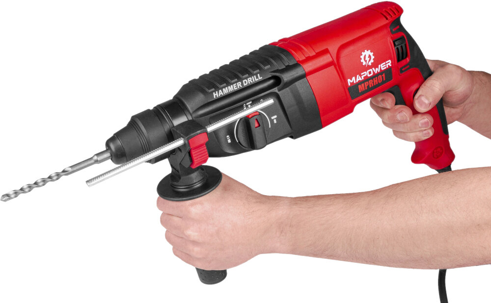Osoba trzyma młotowiertarkę w kolorze czerwono-czarnym z widocznym logo MAPOWER MPRH01 i napisem \'HAMMER DRILL\'. Urządzenie posiada uchwyt pomocniczy i wiertło zamocowane w uchwycie.