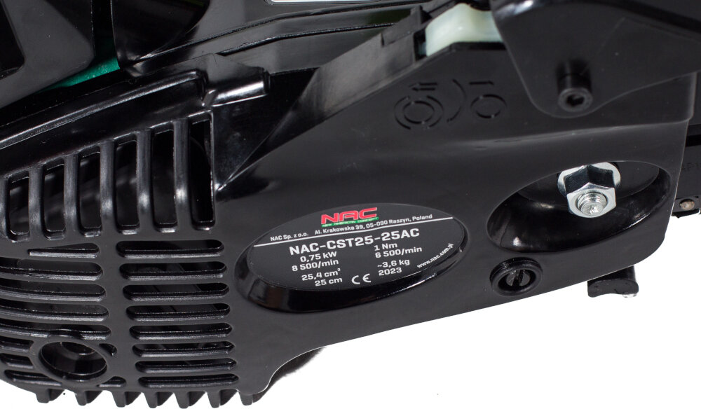 Czarna obudowa piły spalinowej z widoczną etykietą zawierającą tekst: \'NAC CST25-25AC, 0.75 kW, 8500/min, 25.4 cm, 2023\'. Widoczne jest również logo \'NAC\'.