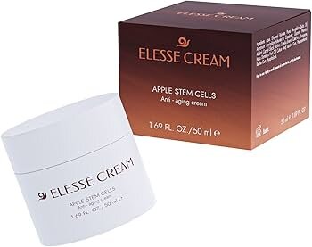 Na obrazie widoczny jest biały słoik z napisem \'ELLESSE CREAM\' oraz pudełko z napisem \'ELLESSE CREAM APPLE STEM CELLS Anti-aging cream 1.69 FL OZ / 50 ml\'.