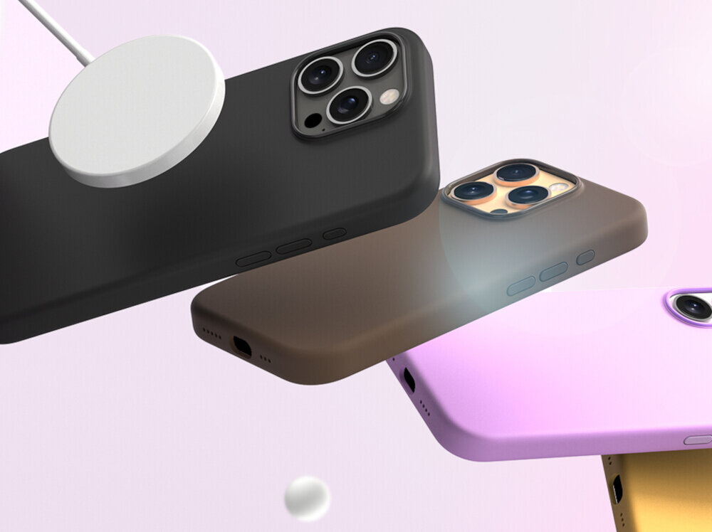 Na obrazie widoczne są trzy etui na telefon w kolorach czarnym, brązowym i różowym, każde z wycięciem na aparat. Obok czarnego etui znajduje się okrągły, biały element przypominający ładowarkę MagSafe.